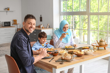 Muslim family having breakfast together. Celebration of Eid al-Fitr