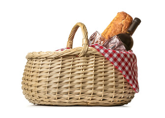 Wicker basket with bread and wine for picnic on white background