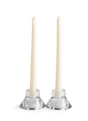 Wax candles in stylish holders on white background
