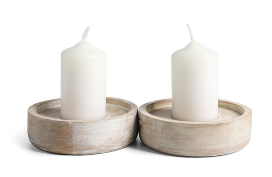 Wax candles in stylish holders on white background
