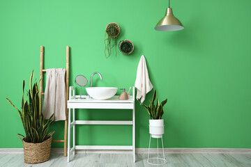 Interior of stylish bathroom with white table, sink and ladder