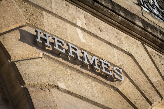 BORDEAUX, FRANCE - FEBRUARY 19, 2022:  Logo of Hermes seen on their Bordeaux main boutique. Hermes is a French luxury goods company specialized in perfumes and fashion...