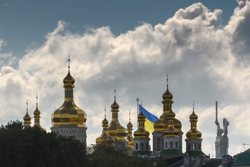 Panorama silhouette view of the Kyiv Pechersk Lavra, The Motherland Monument and Giant State Flag Of Ukraine in Kyiv