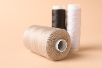Different sewing thread spools on light background