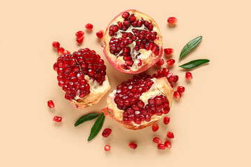 Tasty ripe pomegranate pieces on beige background