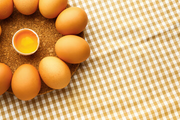 Board with fresh chicken eggs on table