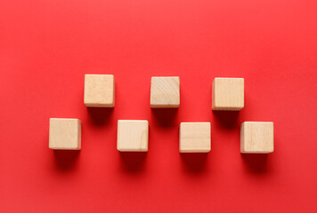 Wooden cubes on red background