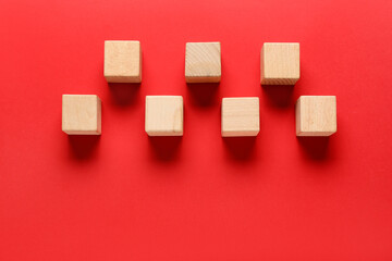 Wooden cubes on red background