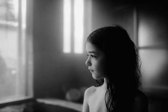 Portrait of a young girl relaxing at a traditional indoors japanese onsen (hot spring) on vacation in Japan (black-and-white)