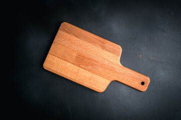 wooden cutting board on an empty black wooden board,food menu concept