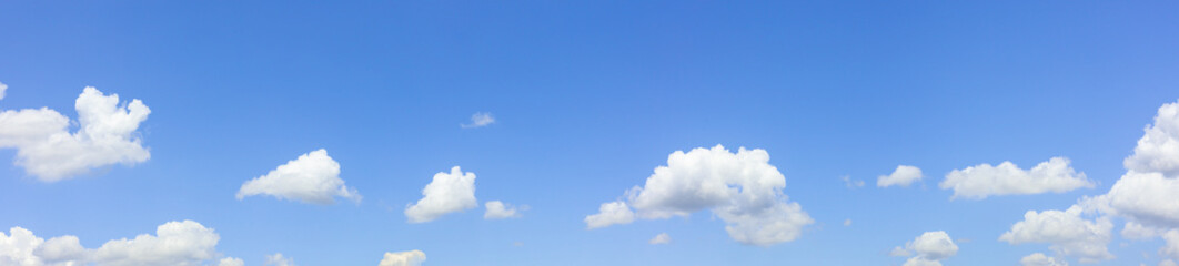 blue sky background with small clouds .