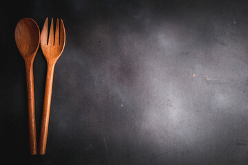 wooden cutlery on an empty black wooden board,food menu concept