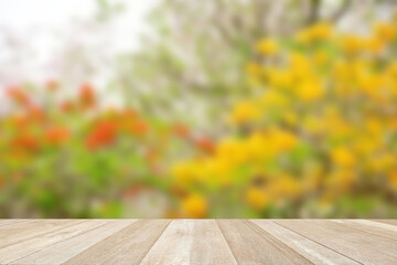 Empty top wooden table on soft focus blurred flowers in nature