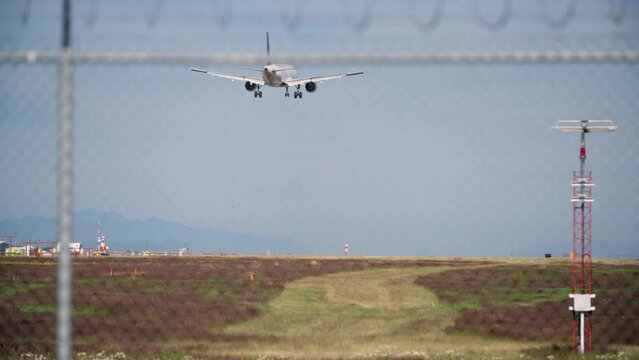 Vancouver Airport Jet Landing Sunshine 4K UHD. A jet airplane touching down. Landing gear down. 4K. UHD.
