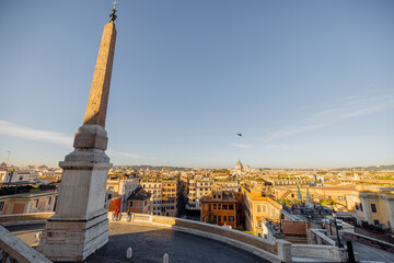 Fototapeta na wymiar Morning cityscape view from the top of Spanish stairs with Sallustiano obelisk in Rome. Traveling Italy concept. Idea of visiting famous italian landmarks
