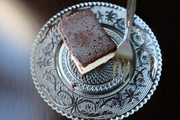 Dairy free ice cream in a container, selective focus. That is ice not grain. Pieces of ice cream cake with vanilla and cocoa. It is called 