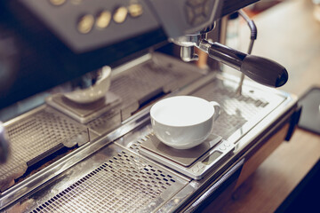 Fototapeta na wymiar Professional coffee machine with cup in cafeteria