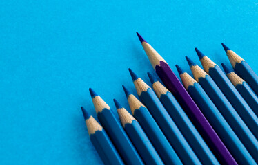 Purple pencil standing out from the crowd