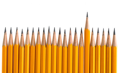 One yellow color pencil standing out from the crowd