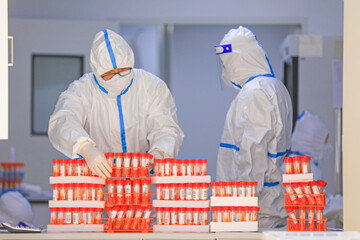 Medical workers are receiving COVID-19 nucleic acid detection specimens at a testing base, North...