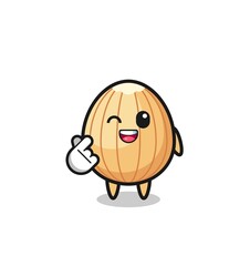 almond character doing Korean finger heart