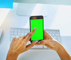 Shes looking for some important numbers on her contact list. Shot of an unrecognizable businesswoman using her cellphone at her office desk at work.