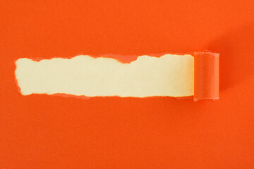 Orange torn paper on yellow background