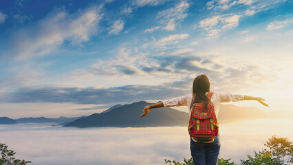 Traveler asian woman with beautiful foggy winter sunrise on the mountains in the northeast of Thailand.