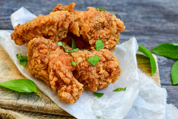 
 Crispy  deep fried   Chicken    strips and Wedges potato. Breaded  with cornflakes chicken  breast fillets  with chilly peppers and fresh   basil on wooden rustic background