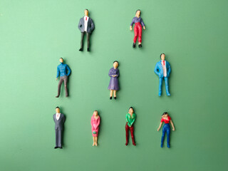 Top view miniature people on a green background.