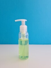 Disinfectants transparent gel green agent on blue background