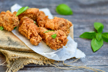 
 Crispy  deep fried   Chicken    strips and Wedges potato. Breaded  with cornflakes chicken  breast fillets  with chilly peppers and fresh   basil on wooden rustic background