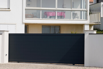 Fototapeta na wymiar portal grey high modern home steel gray door aluminum black gate house