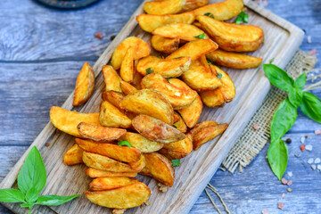  Home made Wedges spicy Potatoes and fresh  lemon on wooden background