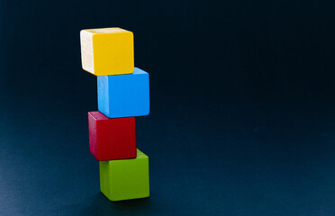 Wooden building blocks stacking on black background