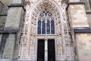 Medieval Cathedral Notre Dame at the old town of Lausanne on a blue and gray cloudy spring day. Photo taken March 18th, 2022, Lausanne, Switzerland.