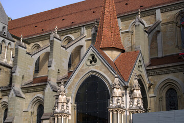 Fototapeta na wymiar Medieval Cathedral Notre Dame at the old town of Lausanne on a blue and gray cloudy spring day. Photo taken March 18th, 2022, Lausanne, Switzerland.