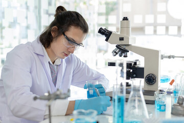 Laboratory diagnosis of synthetic substances, Scientist or researcher examines the substance in vitro and record information, Lab experiments, Researchers scientist working analysis with test tube.