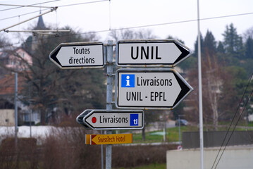 Sign post showing direction to University of Lausanne and technical university of Lausanne EFPL on...