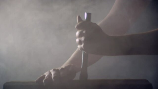 Hammer hitting a big nail in a dramatic misty ambience