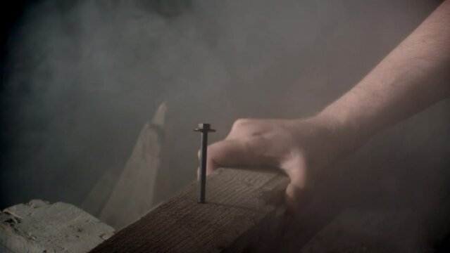 Hammer hitting a big nail in a dramatic misty ambience