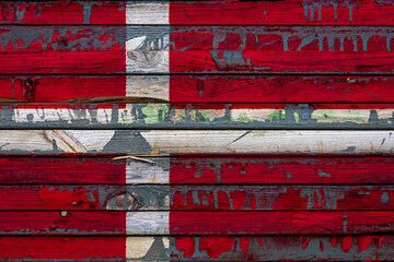 The national flag of Denmark. is painted on uneven boards. Country symbol.