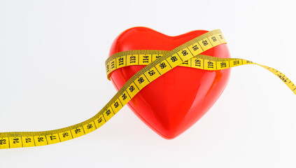 Yellow measuring tape around red heart on white background