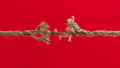 Broken rope on red background