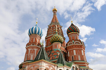 Fototapeta na wymiar St. Basil's Cathedral against the blue sky and white clouds. Russian tourist landmark on Red Square in Moscow