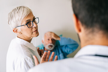 Fototapeta premium Doctor discusses the diagnosis with the worried senior man patient. Healthcare concept