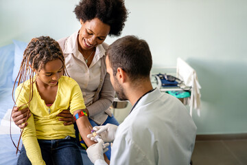 Pediatrician takes blood from a child patient. Healthcare antibody test coronavirus concept