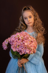 beautiful girl with a big bouquet of hydrangeas