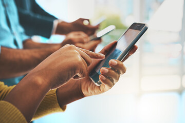 The wireless workforce. Cropped shot of unrecognizable businesspeople using their cellphones in the...