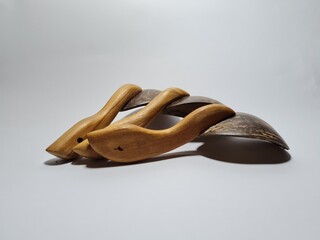Kitchen utensils made of wood and brown coconut shells, namely a large rice spoon
